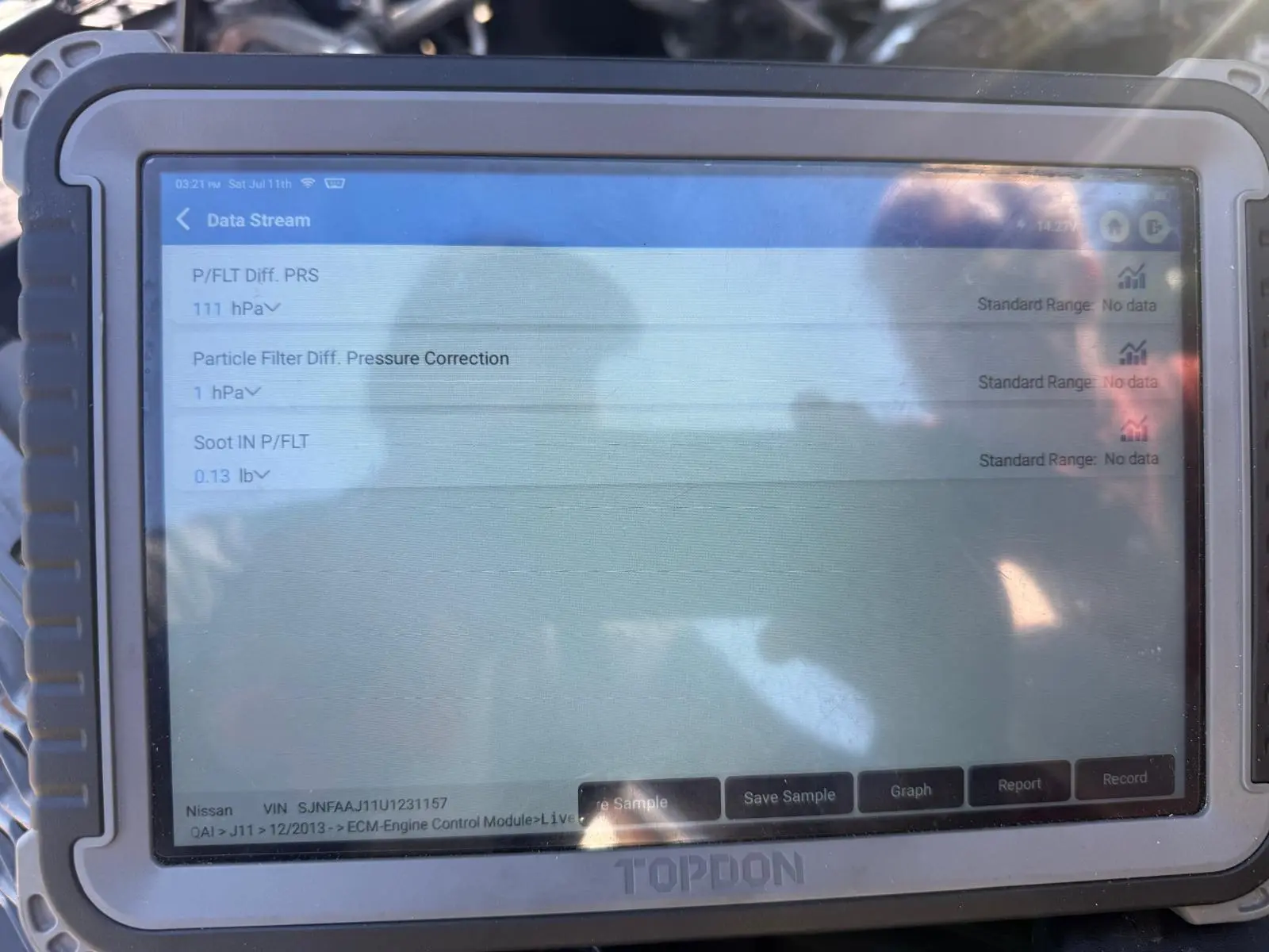 Nissan DPF diagnostic scan showing 111 hPa differential pressure and soot level on a TOPDON diagnostic tablet.