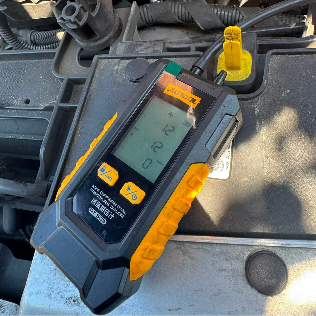 Ford Custom DPF pressure test after cleaning showing a reduced reading of approximately 12 mbar on a diagnostic gauge.